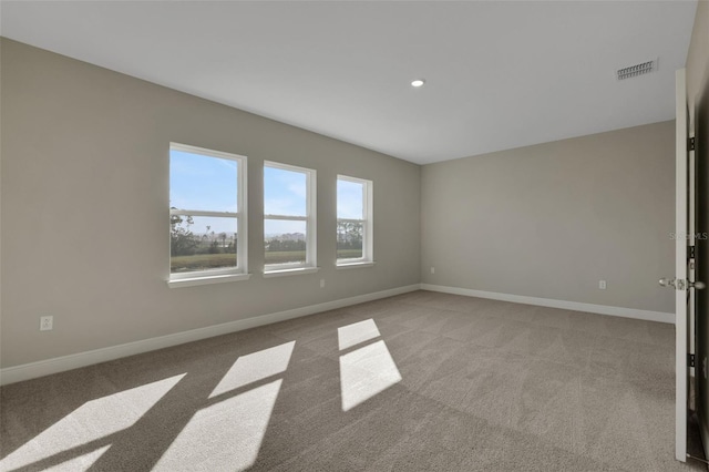 spare room featuring light colored carpet