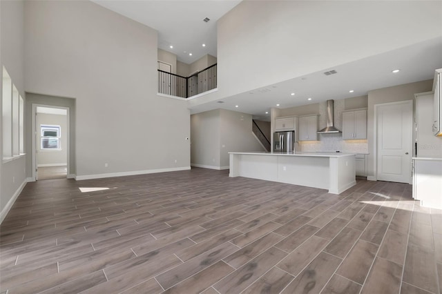 unfurnished living room with a high ceiling