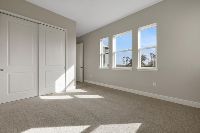 unfurnished bedroom featuring carpet floors and a closet