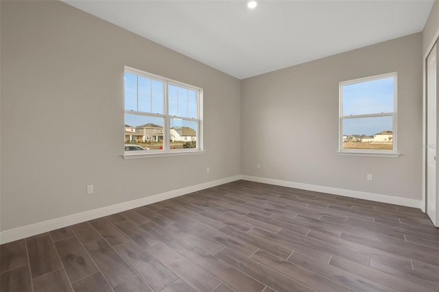 unfurnished room with dark hardwood / wood-style floors