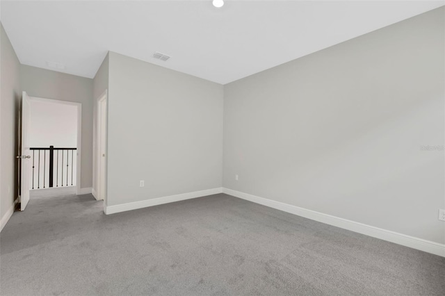 empty room featuring light colored carpet