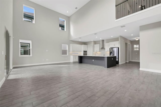 unfurnished living room featuring light hardwood / wood-style flooring and sink