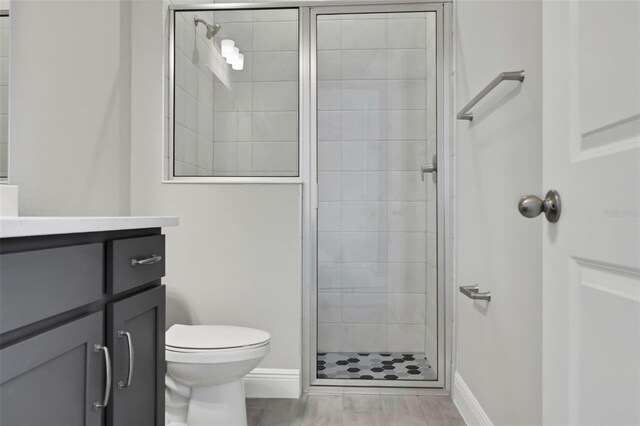 bathroom with vanity, toilet, and walk in shower