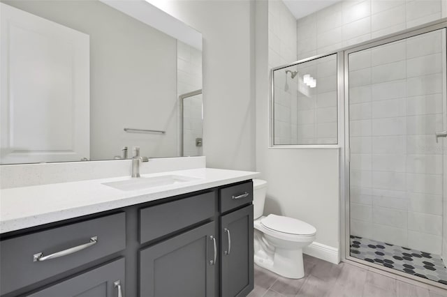 bathroom featuring vanity, toilet, and a shower with door