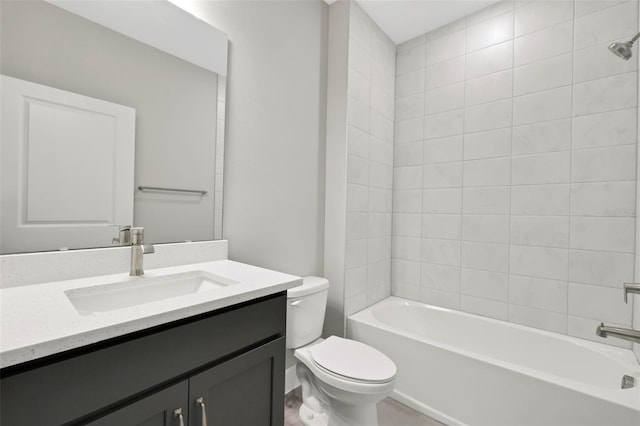 full bathroom with vanity, tiled shower / bath, and toilet