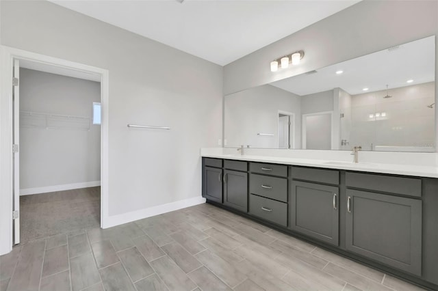 bathroom with vanity and a shower