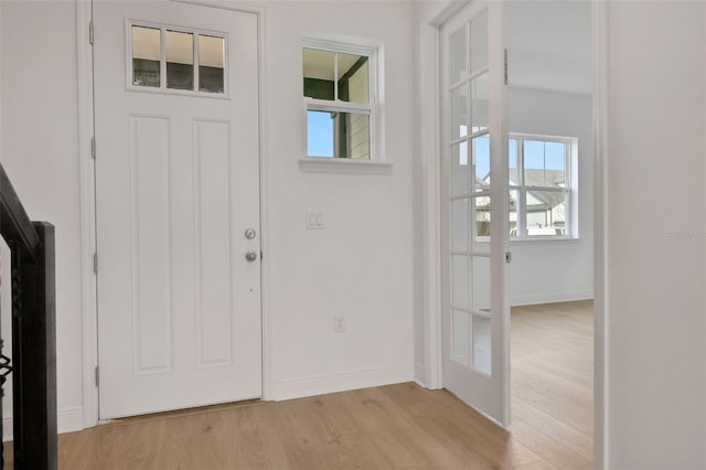 entrance foyer with light wood-type flooring and french doors