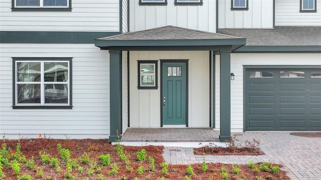 doorway to property with a garage