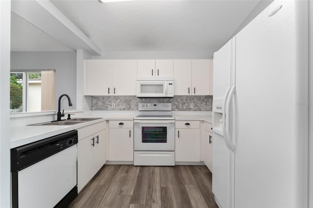 kitchen featuring sink, tasteful backsplash, a textured ceiling, white appliances, and white cabinets