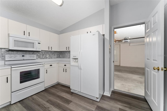 kitchen featuring white cabinetry, dark hardwood / wood-style flooring, vaulted ceiling, a textured ceiling, and white appliances