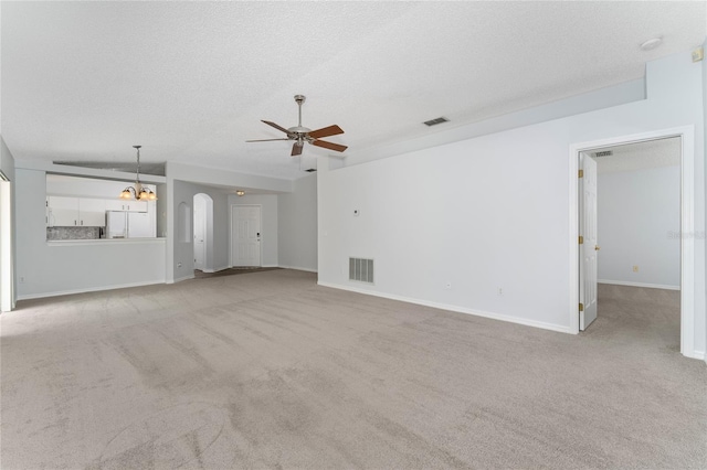 unfurnished living room featuring a textured ceiling, light colored carpet, and ceiling fan