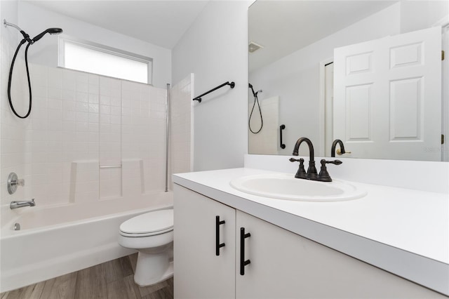 full bathroom featuring toilet, hardwood / wood-style floors, vanity, and bathing tub / shower combination