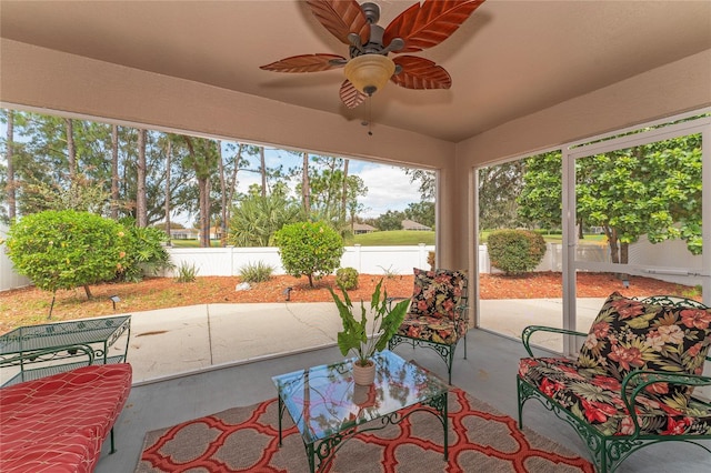 sunroom featuring ceiling fan