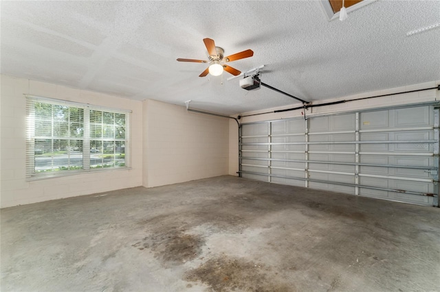 garage featuring ceiling fan and a garage door opener