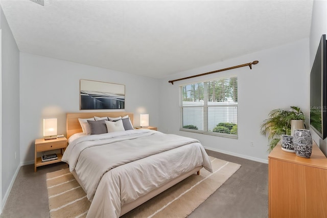 bedroom featuring dark carpet