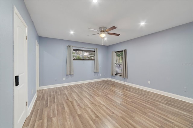 empty room with ceiling fan and light wood-type flooring