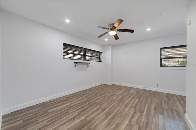 spare room featuring hardwood / wood-style floors and ceiling fan