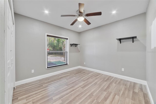 spare room featuring ceiling fan and light hardwood / wood-style floors