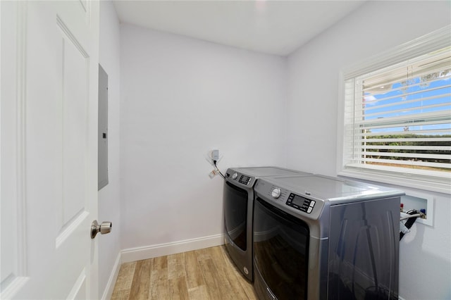 laundry area featuring light hardwood / wood-style floors and washing machine and dryer