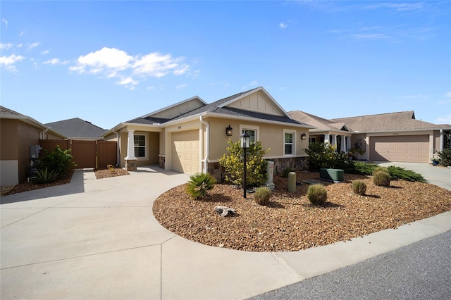 ranch-style house featuring a garage and cooling unit