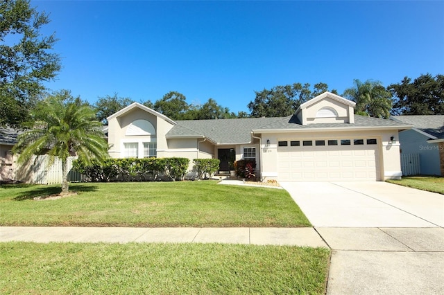 view of front of property featuring a front yard and a garage