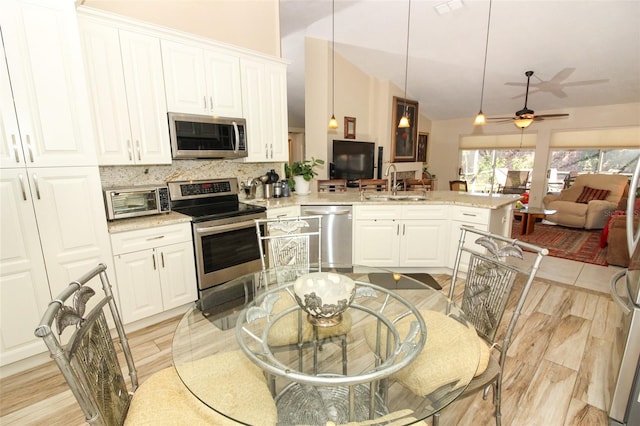 kitchen featuring white cabinets, sink, appliances with stainless steel finishes, and tasteful backsplash