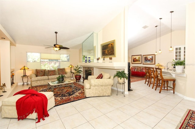 tiled living room with ceiling fan and vaulted ceiling