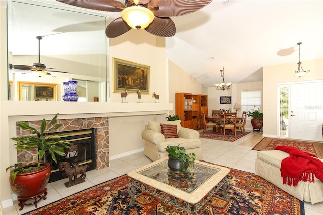 living room with a stone fireplace, ceiling fan with notable chandelier, light tile patterned floors, and lofted ceiling