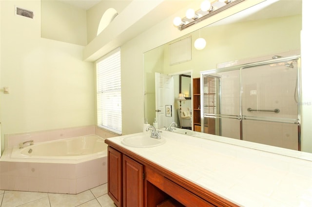 bathroom with tile patterned flooring, vanity, and shower with separate bathtub