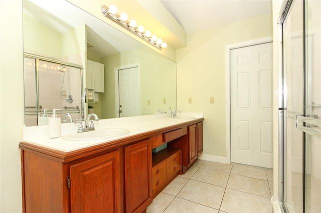 bathroom featuring tile patterned flooring, vanity, and an enclosed shower