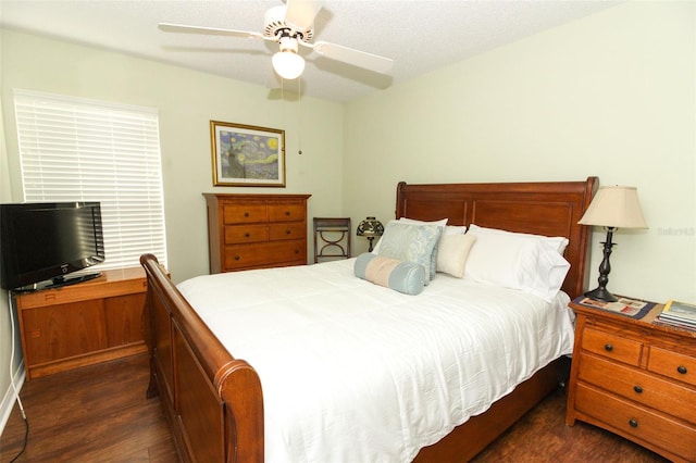 bedroom with a textured ceiling, dark hardwood / wood-style floors, and ceiling fan