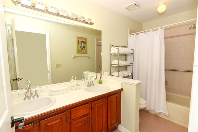 full bathroom featuring tile patterned flooring, vanity, toilet, and shower / tub combo with curtain