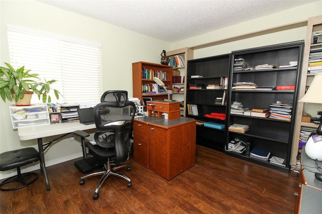 office area with a textured ceiling and dark wood-type flooring