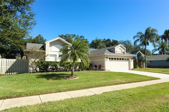 view of front of house featuring a garage and a front lawn