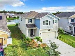 view of front facade with a garage and a front lawn