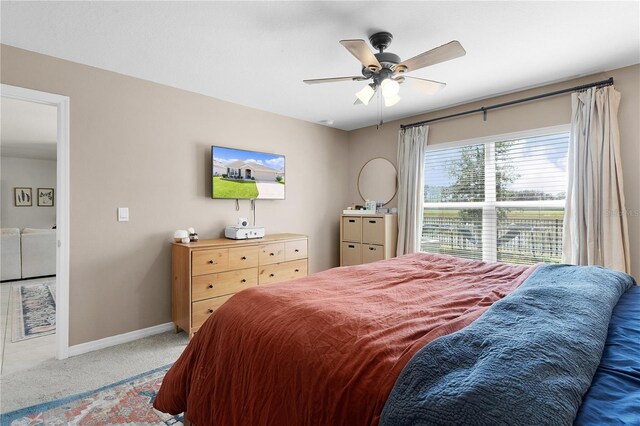 bedroom featuring ceiling fan and carpet