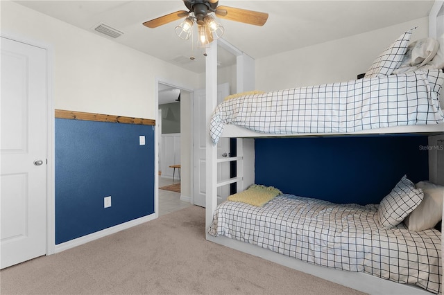 bedroom with ceiling fan and light carpet