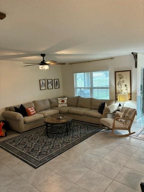 living room with light tile patterned floors and ceiling fan