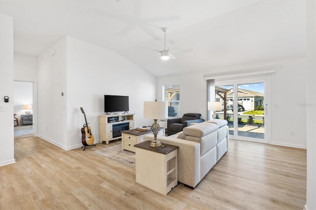 living room featuring lofted ceiling, light hardwood / wood-style flooring, and ceiling fan