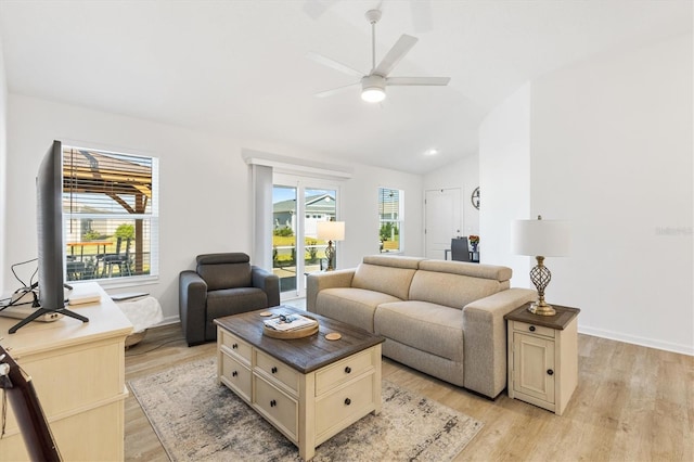 living room featuring lofted ceiling, light wood-type flooring, and ceiling fan