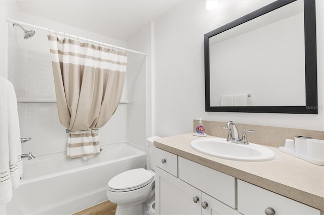 full bathroom with vanity, hardwood / wood-style floors, shower / bath combo, and toilet