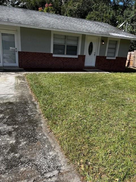 620 Gould St, Eustis, FL 32726 - view of front of home with brick siding and roof with shingles