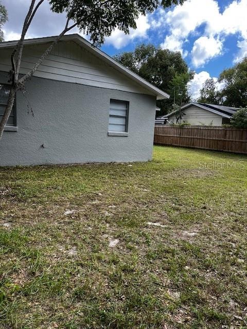 view of side of property featuring a yard