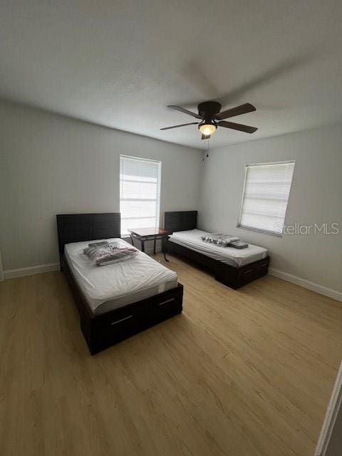 bedroom featuring light wood-type flooring and ceiling fan