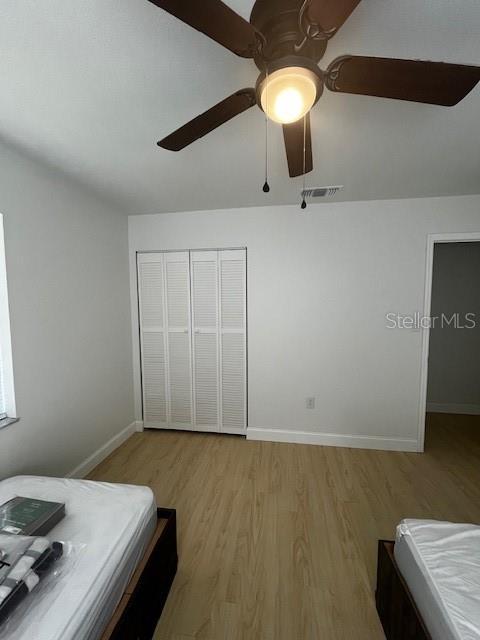620 Gould St, Eustis, FL 32726 - bedroom featuring light wood-type flooring, baseboards, a closet, and ceiling fan