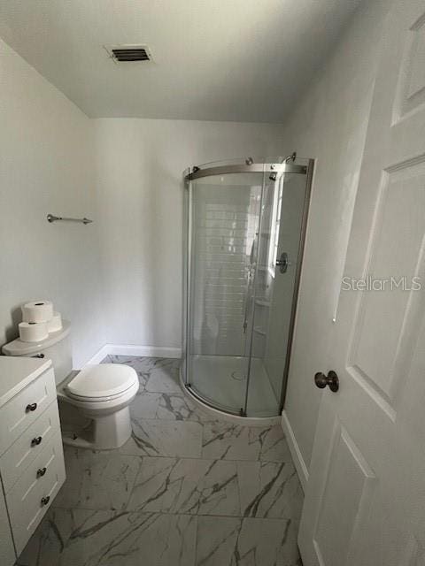 bathroom with a shower with door, toilet, and vanity