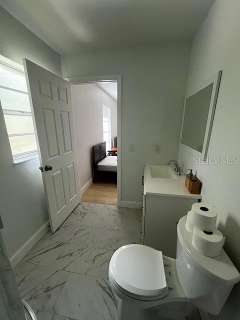 620 Gould St, Eustis, FL 32726 - bathroom with toilet, marble finish flooring, baseboards, and vanity