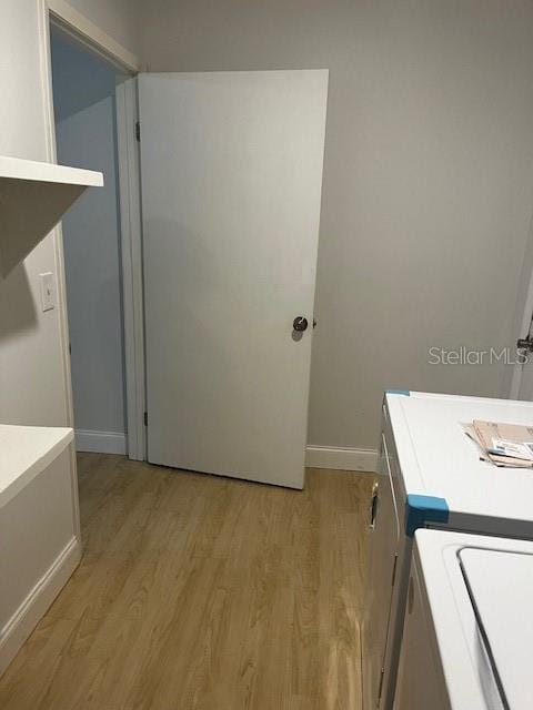 clothes washing area with light hardwood / wood-style floors