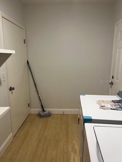 620 Gould St, Eustis, FL 32726 - laundry room with light wood-type flooring and baseboards