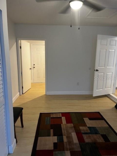 unfurnished room with ceiling fan and hardwood / wood-style flooring